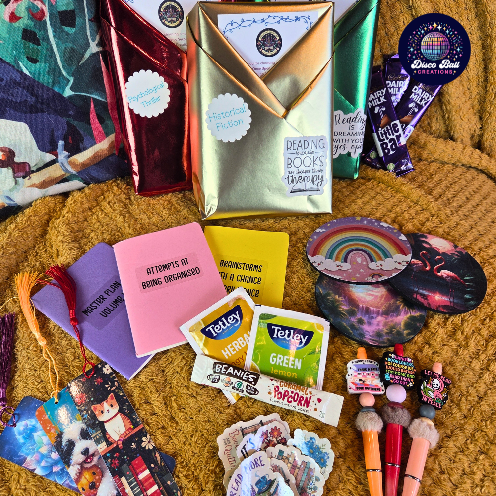 Assorted items including Tetley tea bags, colorful cards, and decorative objects on a textured surface.