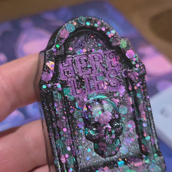 A 7 second video showing the grave stone ornament from various angles being held in a hand