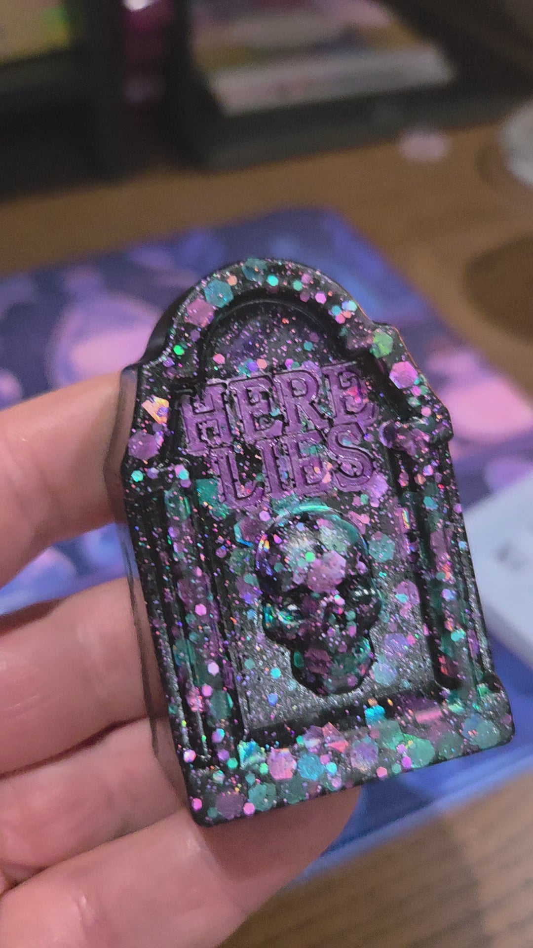 A 7 second video showing the grave stone ornament from various angles being held in a hand